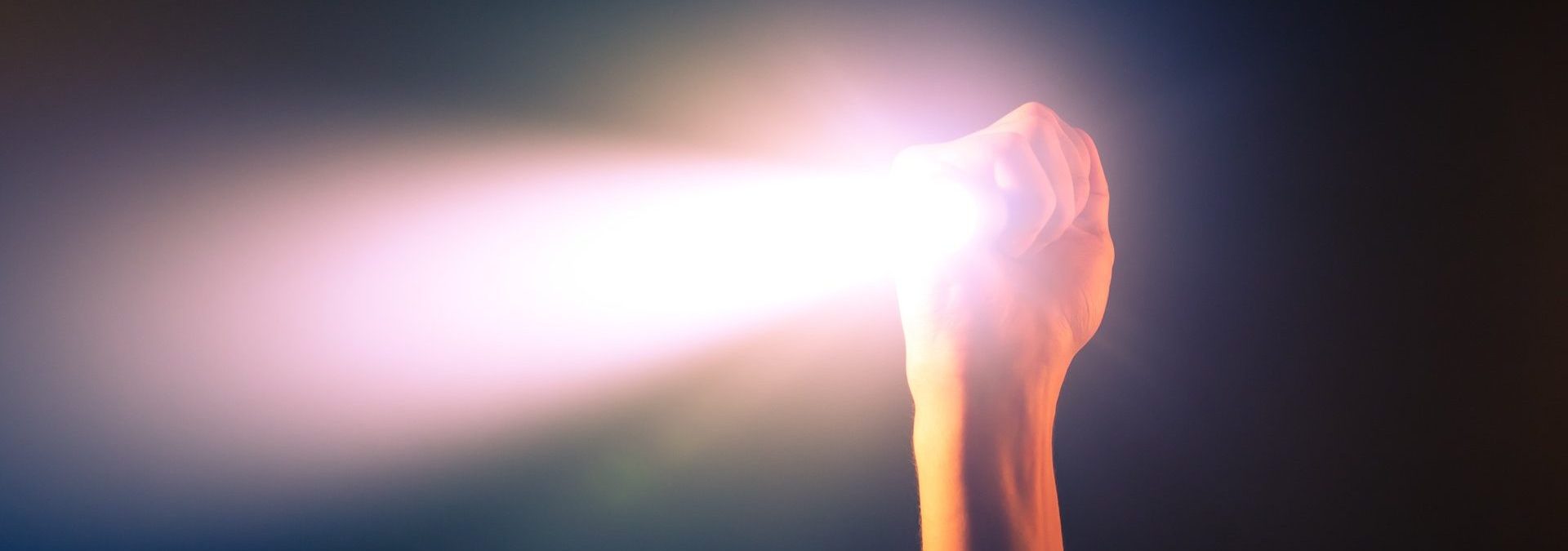 a hand holding a flashlight